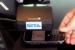 A passenger scanning their mobile phone.