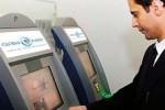 A passenger using a Global Entry kiosk.