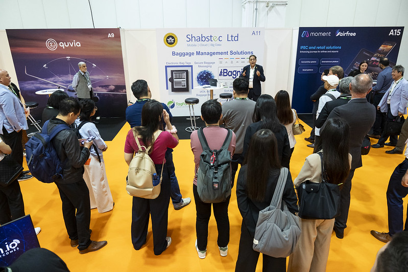 Exhibitor presenting pre-travel solutions during guided tech briefing