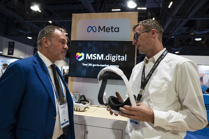 Attendees interacting with technology at the FTE exhibition
