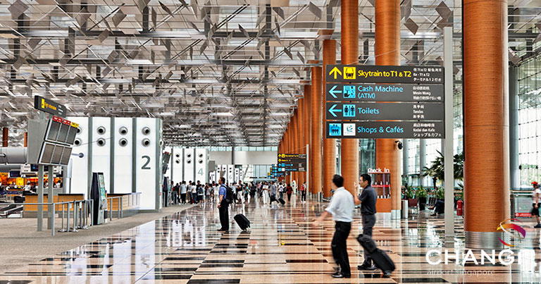 Photograph of passengers walking through a Changi Airport terminal