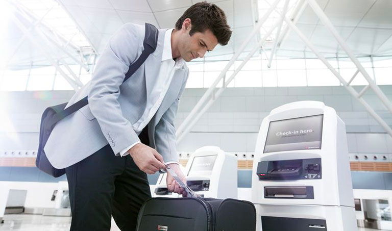 Photograph of a passenger self-bag-tagging at an airport