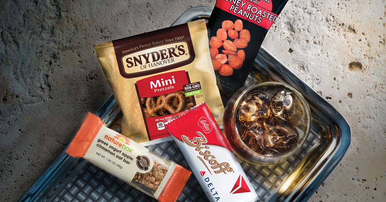 Delta is unveiling its improved onboard lineup including Snyder’s of Hanover pretzels, Squirrel Brand Honey Roasted peanuts and NatureBox Apple Cinnamon Yogurt Bars. The enhancement will feature larger portions and more variety for customers while supporting Delta’s mission of continuing to invest in the overall on-board experience.